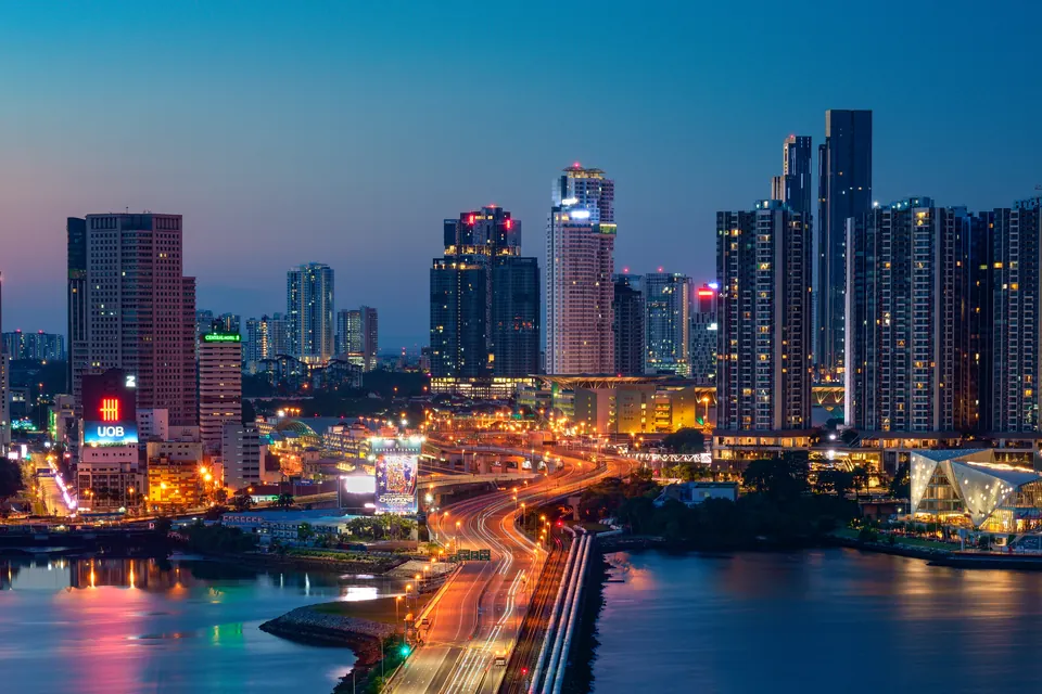 Cigar Shop Johor Bahru: Lounges, Rules and the Singapore Crossing — johor Bahru city skyline and waterfront highway lit up at dusk